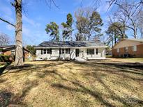 Charming single-story home with manicured lawn and inviting front porch at 5901 Craftsbury Dr, Charlotte, NC 28215