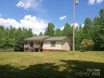 Charming single-story home with a covered front porch and large yard at 607 Anthony Grove Rd, Crouse, NC 28033