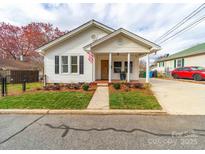 Charming single-story home featuring a welcoming front porch and well-maintained landscaping at 719 Washington St, Cramerton, NC 28032