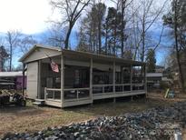 Charming exterior of a residence featuring a spacious porch and a well-maintained landscape, perfect for outdoor living at 109 Pembrooke Trl # F171, Mount Gilead, NC 27306
