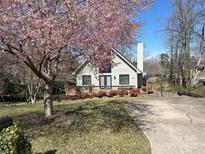 Charming home featuring a well-manicured lawn, blossoming tree, and inviting deck at 1220 Nw 20Th Avenue Nw Ave, Hickory, NC 28601