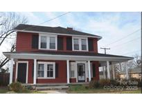 Charming two-story home with a covered front porch and classic architectural details at 129 Maupin Ave, Salisbury, NC 28144