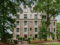 Multi-story brick and stone building with lush green landscaping at 1333 Queens Rd # B1, Charlotte, NC 28207