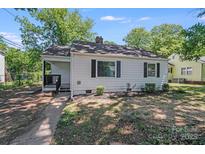 Charming single-story home featuring a classic design, a well-maintained yard, and a welcoming front porch at 2328 Edison St, Charlotte, NC 28206