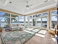 Spacious living area with waterfront views, hardwood floors, recessed lighting, and a ceiling fan at 3030 Point Clear Dr, Tega Cay, SC 29708