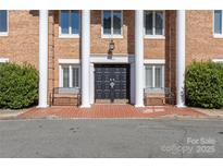 Elegant brick building features a grand double door entrance with benches and stately columns at 4527 Gaynor Rd # 107, Charlotte, NC 28211