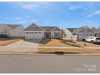 Charming single-story home with a two-car garage, well-maintained lawn, and inviting curb appeal at 609 Grandiflora Ave, Lancaster, SC 29720