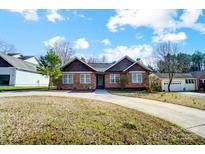 Charming single-story brick home with a well-manicured lawn and a long driveway at 6618 Alexander Rd, Charlotte, NC 28270