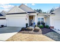 Charming single-story home featuring a well-manicured lawn, front porch, and attached two-car garage at 9005 Smokey Hill Ln, Indian Land, SC 29707