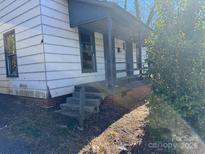 An exterior elevation showing the entrance to a property featuring a small porch and concrete steps at 981 15Th St # 16, Lancaster, SC 29720