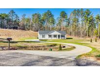 Charming one-story home with a circular driveway and well-maintained lawn at 1076 Westminster Dr, Lancaster, SC 29720