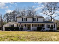 Charming two-story home with a welcoming front porch and well-maintained landscaping at 1201 Edgefield Ave, Gastonia, NC 28052