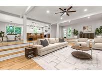 Bright living room with hardwood floors, neutral decor, open to kitchen and dining areas at 16137 Tana Tea Cir, Tega Cay, SC 29708