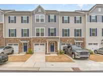Charming townhome with stone accents, two-car garage, and inviting curb appeal at 2311 Doby Creek Ln, Charlotte, NC 28262