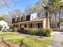 Charming two-story home with brick accents, dormer windows, and a well-manicured front yard at 2600 Lawton Bluff Rd, Charlotte, NC 28226