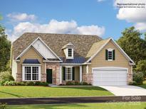 Charming single-Gathering home with stone accents, manicured lawn, and inviting curb appeal at 4144 Camden Glen Rd, Lancaster, SC 29720