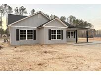 Charming gray home with black shutters and a covered front porch at 553 Wateree St, Lancaster, SC 29720