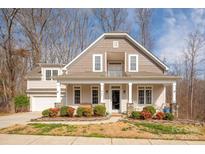 Charming home featuring a large front porch, beautiful landscaping, and a welcoming entrance at 8105 Dumphries Dr, Huntersville, NC 28078