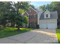 Charming two-story home features a brick facade and attached two-car garage at 9138 Babbitt Way, Charlotte, NC 28216