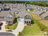 Aerial view of a beautiful two-story home with manicured landscaping, a two-car garage, and a welcoming front porch at 1017 Cheviot Ct, Waxhaw, NC 28173
