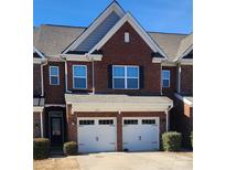Charming brick townhome with a two-car garage and well-maintained front landscaping at 113 Burlingame Ct # D, Mooresville, NC 28117