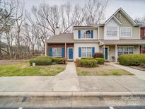 Charming townhome featuring blue shutters, a well-manicured lawn, and a welcoming entrance at 12601 Tucker Crossing Ln, Charlotte, NC 28273