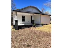 Charming exterior view of home with black brick foundation and a cozy, covered front porch area at 1417 W A St, Kannapolis, NC 28081