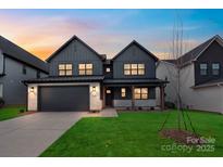 Beautiful two-story home featuring a modern design, well-manicured lawn, and a spacious two-car garage at 147 Windy Dell Dr, Tega Cay, SC 29708