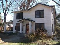 Charming two-story home with black window frames and a covered front porch at 322 E Houston St, Monroe, NC 28112