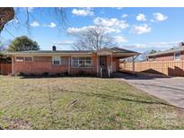Charming brick ranch-style home featuring a cozy carport and a well-maintained front yard at 602 Charles Rd, Shelby, NC 28152