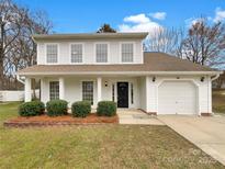 Charming two-story home with a well-manicured lawn and a classic white exterior at 9203 Christina Marie Ct, Charlotte, NC 28213