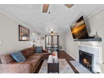 Inviting living room features a fireplace, wood floors, and a comfortable leather couch at 106 Biltmore Ave, China Grove, NC 28023