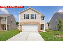 New two-story home with a two-car garage, brick accents, and a well-manicured lawn at 11217 Cardinal Creek Ave, Charlotte, NC 28215