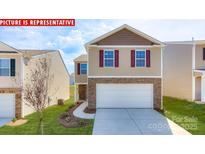 Charming two-story home with stone accents, a two-car garage, and a well-manicured lawn at 11225 Cardinal Creek Ave, Charlotte, NC 28215