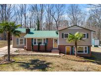 Charming home with a well-maintained lawn and a striking green roof at 121 Alexis Forest Dr, Stanley, NC 28164