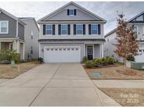 Charming two-story home with a two car garage, black shutters and well maintained landscaping at 15040 Cordelia Dr, Charlotte, NC 28278