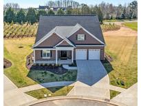 Beautiful two-story home featuring a two-car garage, landscaped yard, and covered entryway at 19031 Brandon James Dr, Cornelius, NC 28031