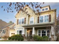 Charming home featuring stone accents, a covered porch, and beautifully maintained landscaping at 19908 Wooden Tee Dr, Davidson, NC 28036