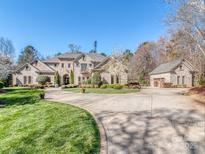 Impressive brick home with a circular driveway, mature landscaping, and an attached garage at 235 Blue River Rd, Clover, SC 29710