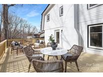 Relaxing outdoor deck area with stylish seating and a white round table at 301 Dollar Cir, Charlotte, NC 28270