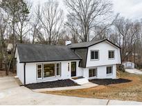 Charming two-story home with white brick, black trim, and a welcoming front entrance at 301 Dollar Cir, Charlotte, NC 28270