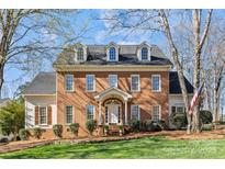 Charming two-story brick home with dormer windows and a well-manicured front lawn at 5618 Camilla Dr, Charlotte, NC 28226