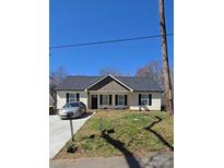 Charming single-story home with a well-manicured lawn and inviting curb appeal at 648 E Ketchie St, China Grove, NC 28023
