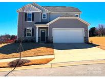 Charming two-story home featuring a gray exterior, two-car garage, and well-maintained front lawn at 705 Hallman Branch Ln, Lincolnton, NC 28092