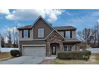 Charming two-story home featuring a stone-accented entrance, attached garage, and well-maintained landscaping at 8055 Hereford St, Charlotte, NC 28213