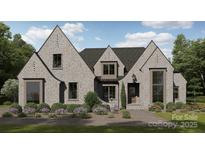 Magnificent brick home featuring a well-manicured lawn and beautifully landscaped flower beds at 102 Pecan Cove Ln, Weddington, NC 28104