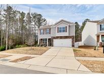 Charming two-story home featuring stone accents, neutral siding, and a two-car garage at 16138 Aryshire Green Ct, Charlotte, NC 28273