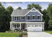 Charming two-story home featuring a two-car garage, well-manicured lawn, and welcoming front porch perfect for relaxing at 1805 Ab Moore Jr Dr # 3237, Indian Trail, NC 28079