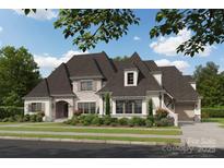 Beautiful two-story home featuring stone accents, an arched entryway, manicured landscaping, and a spacious driveway at 211 Sugar Maple Ln, Weddington, NC 28104