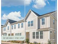 Charming end-unit townhouse with modern siding, bright windows, and well-manicured landscaping at 554 Amalfi Dr, Davidson, NC 28036